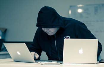 hacker with two laptops
